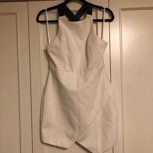 White dress with black leather accent straps.